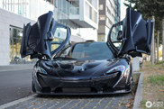 A happy kid gets a ride in this McLaren P1